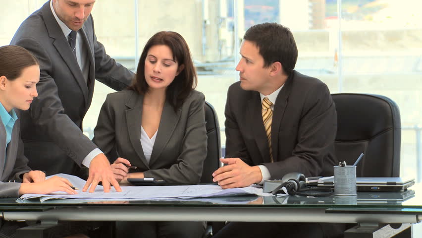 Businessman showing his colleague a document during a meeting in an office