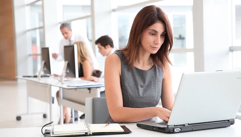 Businesswoman in office with laptop computer