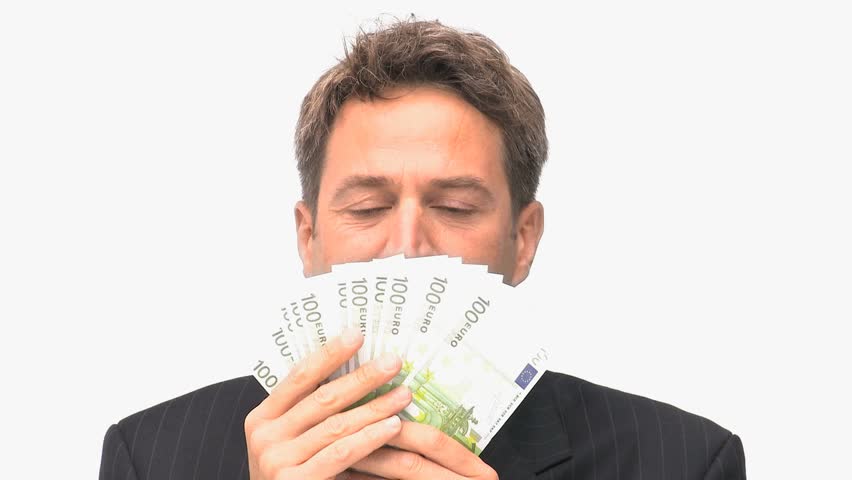 Businessman smelling his money