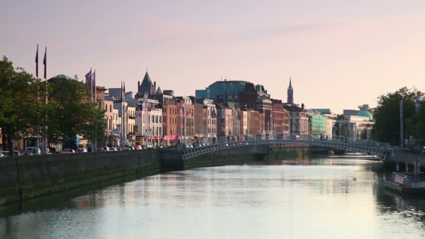 People cross the Ha'penny bridge in Dublin, Ireland. 