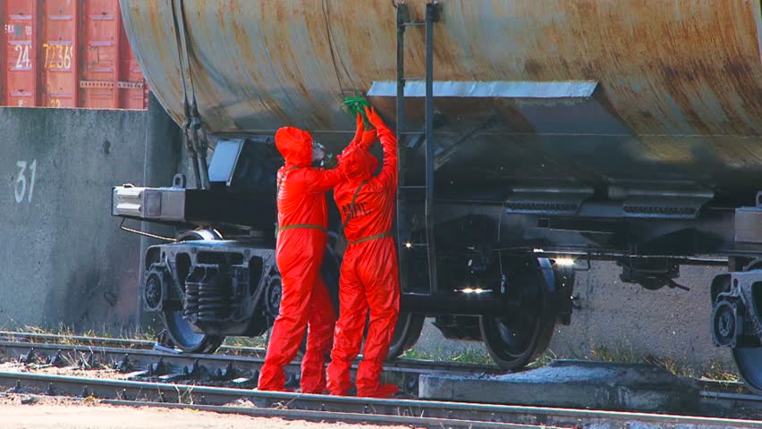 Struggle with the disaster. A group of men in protective suits are trying to prevent a catastrophe. Two frames.