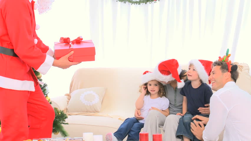 Santa Claus offering a gift to a little boy
