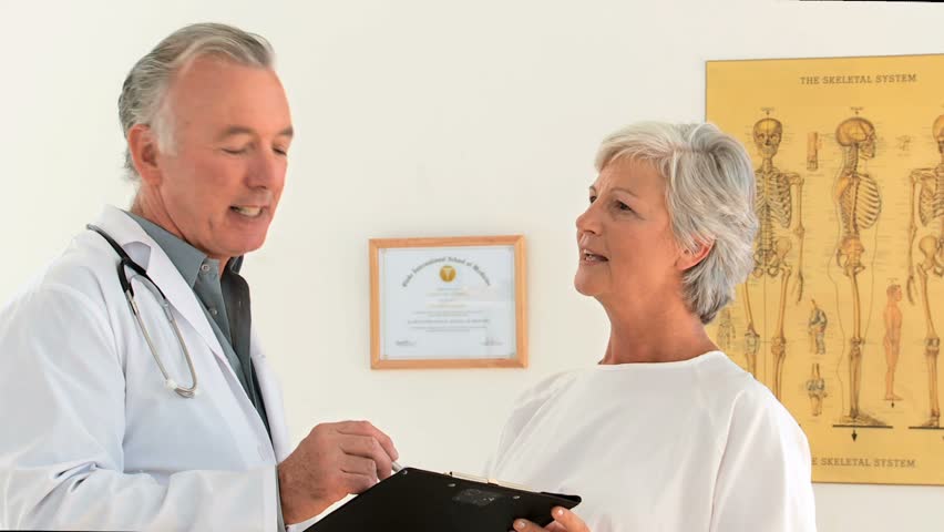 A patient answering her doctor about a few questions in the surgery