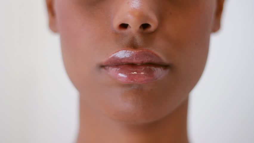 Shhh! Girl puts fingers to lips. Shallow depth of field. 