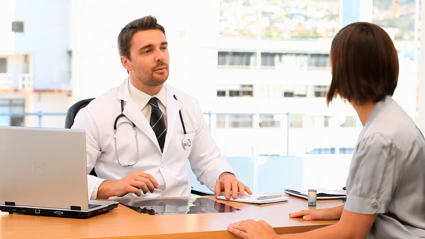 Doctor Asking Questions To His Patient In The Medical Office Stock ...