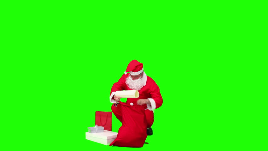 Santa Claus preparing himself against a green screen