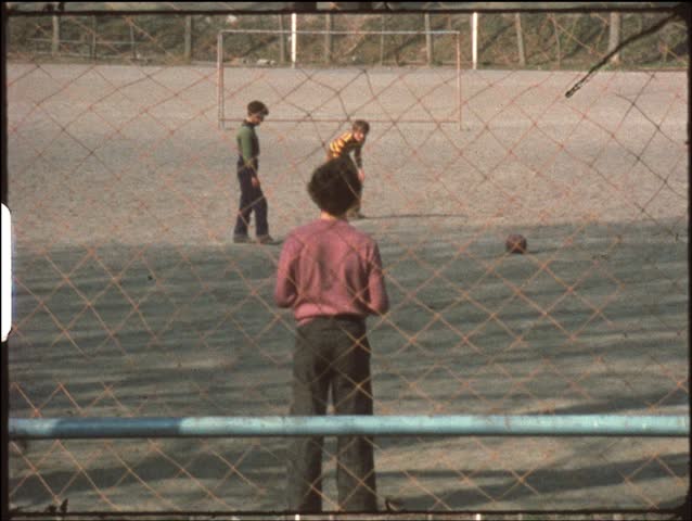 Boys playing penalty shootout (vintage 8mm film)