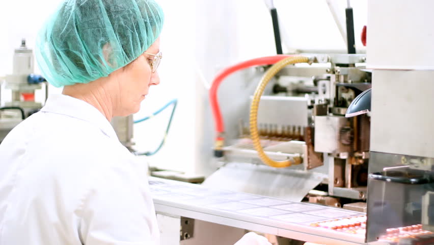 Robotic arm lifting ampules at packaging line in pharmaceutical factory. HD 1080p.