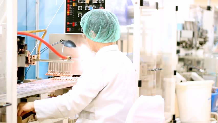 Robotic arm lifting ampules at packaging line in pharmaceutical factory.  HD 1080p.