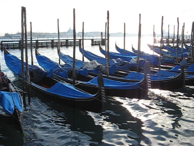 Venice: Backlighted parked Gondolas in front of St.Mark square