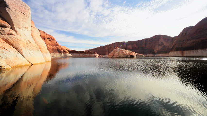 Traveling the clear waters of Lake Powell through sandstone rock canyons