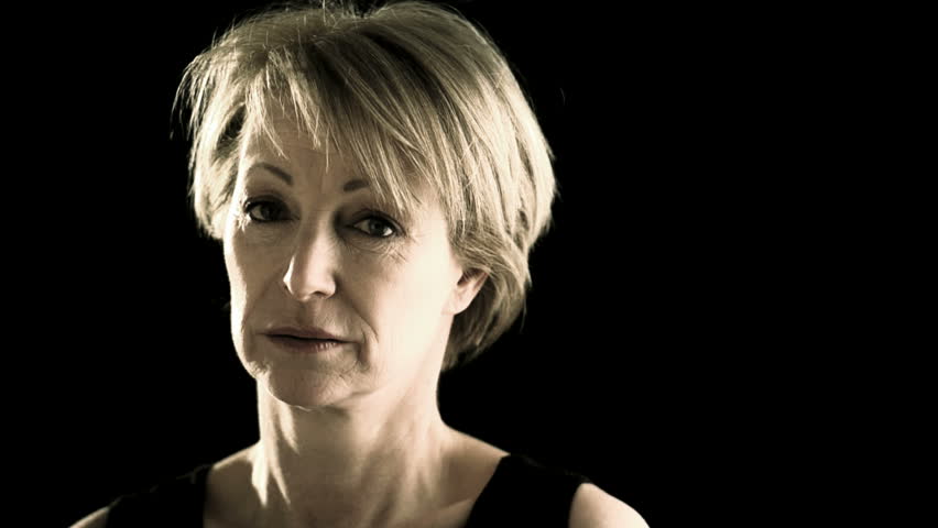 Sad/pensive mature woman on black; HD Photo JPEG