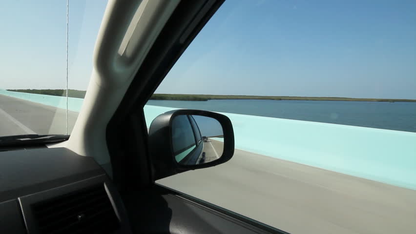 Driving in Florida. Turquoise causeway. Driving across a causeway in the Florida Keys. Passing turquoise coloured barrier. 