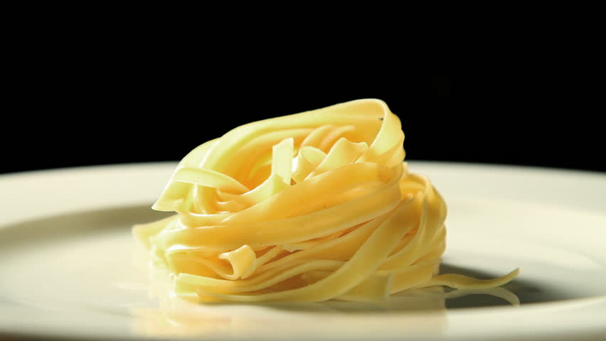 putting mushroom sauce on tagliatelle