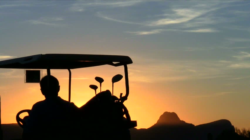 Golf cart silhouette at sunset close-up