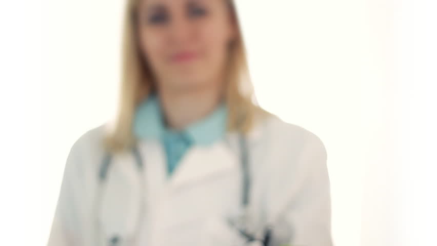 Female doctor hand offering green apple, isolated