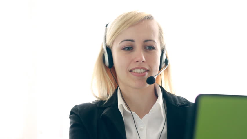 Attractive helpdesk consultant talking on headset
