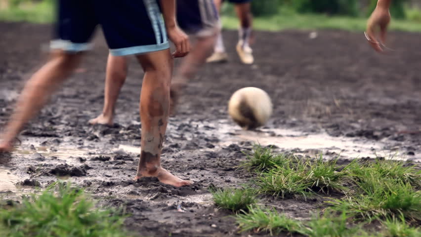 A gang of bar feet kids playing soccer on a muddy field. Serial of slow motion shots with depth of field effects. Action loaded details of running legs and goal shots. [b]HD1080 | 30fps[/b]