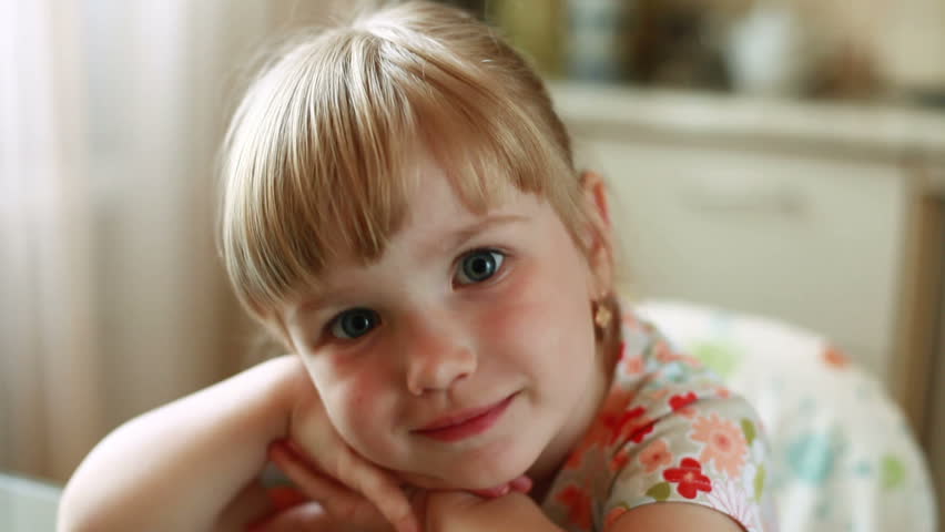Happy child smile at camera, gives thumbs up 
