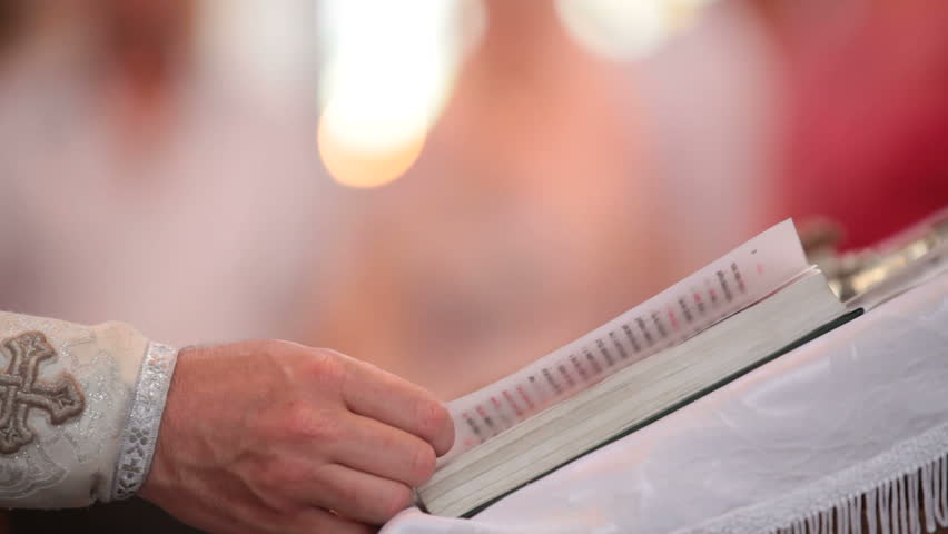 Priest reading the Bible in church