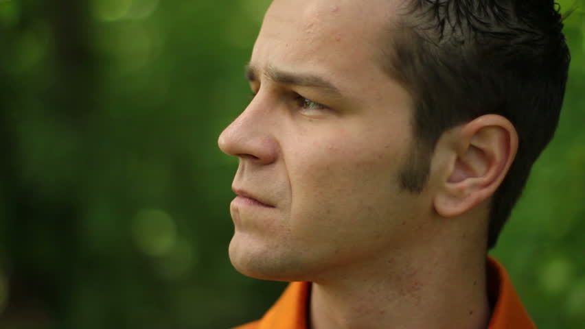 Man looking at camera and smiling outdoors