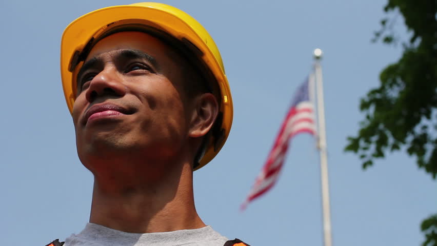 Proud worker in front of American flag