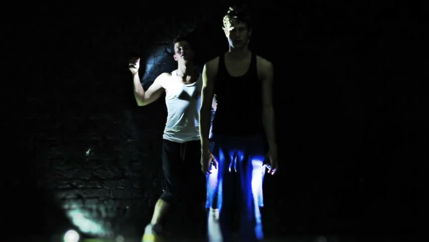 Two men dancing on wall background. 