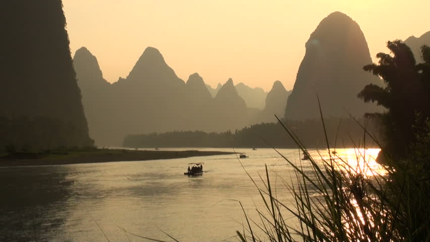 Amazing vista over Li river and karst scenery and a few tourist boats in the backdrop.