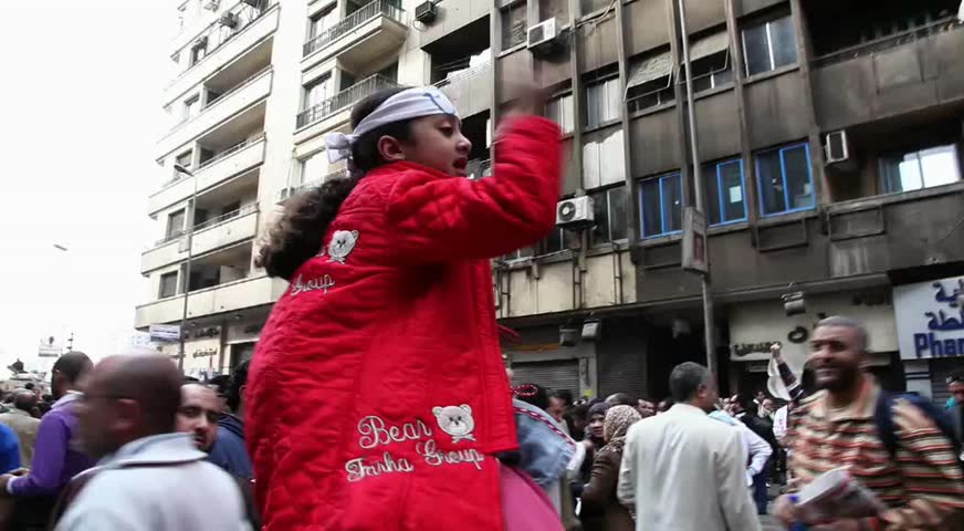 CAIRO - CIRCA JAN 2011: Small girl guides protesters in Tahrir Square circa January 2011, Cairo, Egypt. Tahrir Square was the focal point of the 2011 Egyptian Revolution where demonstrations grew to 250,000 plus people by day 6, January 31, 2011. 