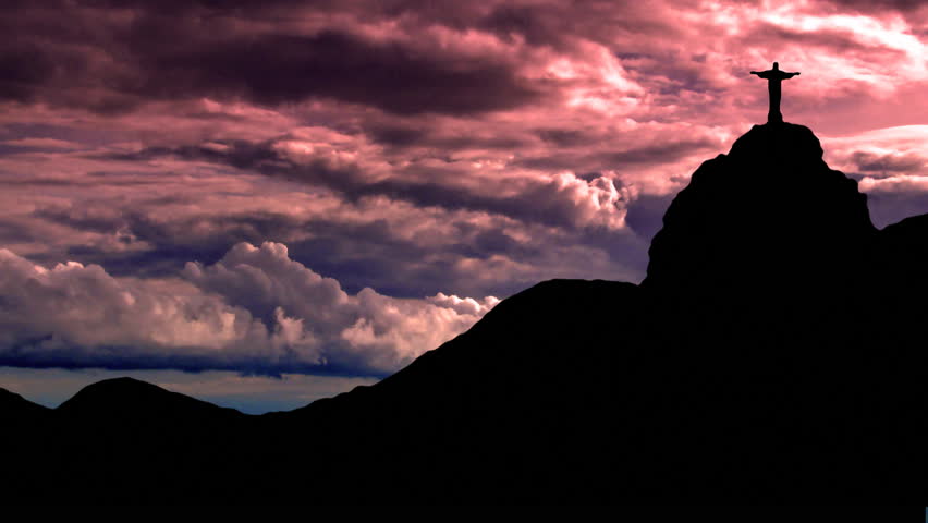 Statue of Christ on Sugarloaf, in Rio de Janeiro, Brasil, with the storm formating behind as the sun fells down.
