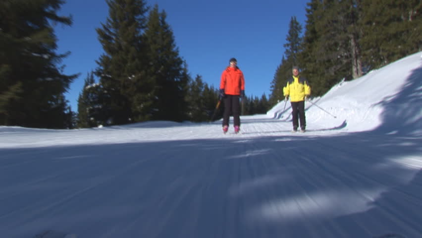 two skiers following camera