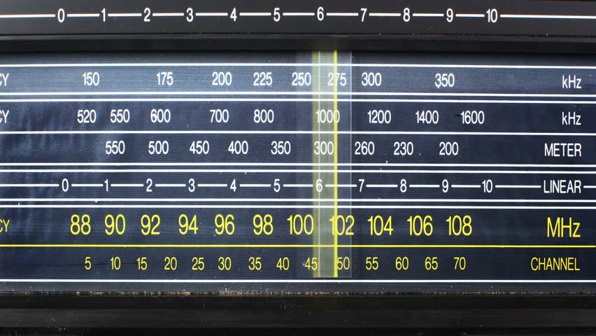 an analogue radio dial tuning in different radio frequencies