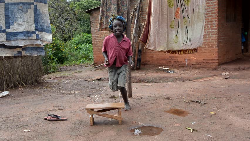 SALIMA, MALAWI - APRIL 7: Unidentified girl plays with a skipping rope, April 7, 2011, Salima, Malawi. African children build their toys. 