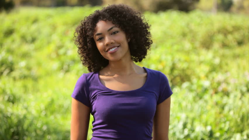 Young woman laughing in field