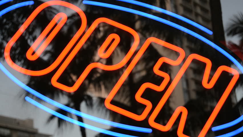A flashing neon open sign outside a store or restaurant