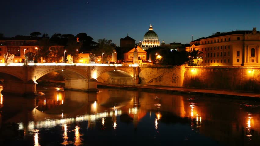 Cityscape bridge over the river, the dome of Saint Peters Cathedral is seen behind the buildings
