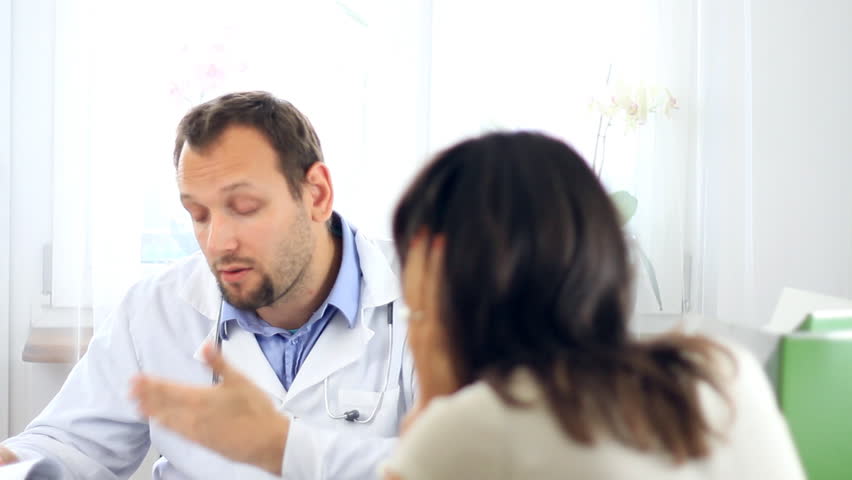Male doctor telling bad news to female patient