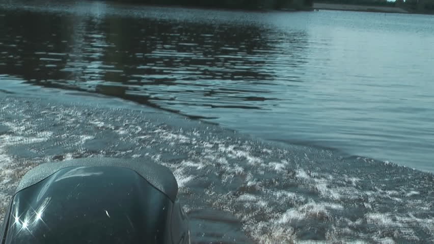 Motorboat floats on lake.