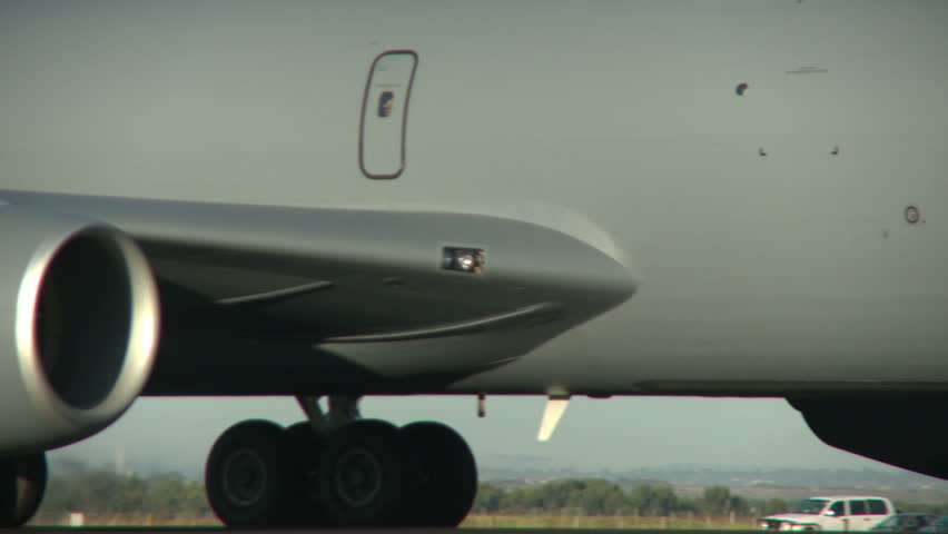 A stratotankers engines and landing gear taxiing down the runway