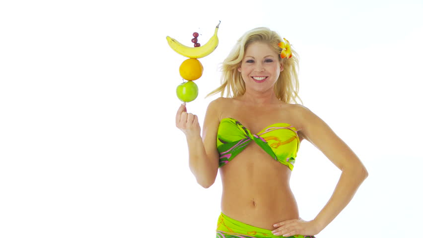 Woman balancing fruit on finger