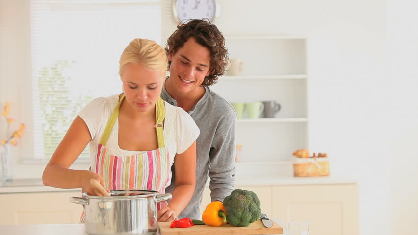 Happy couple cooking together in the kitchen