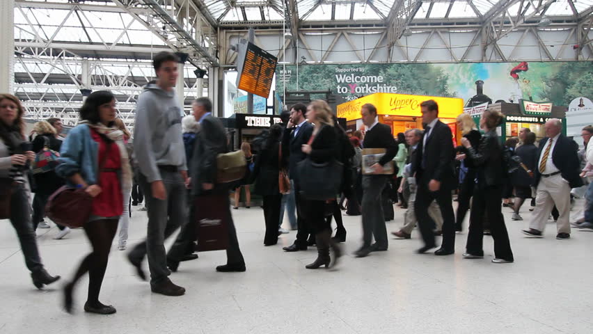 LONDON, UK - JULY 21: Train travelers walk through the central hall of Waterloo Station on July 21, 2011 in London, UK. Waterloo Station is the second busiest railway station of London.