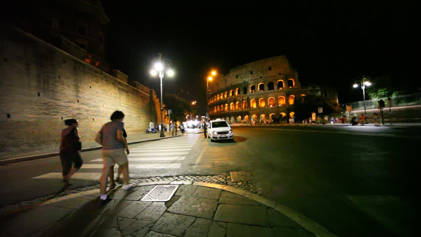 ROME - AUGUST 4: Pedestrian crossing near Colosseum at night on August 4, 2010 in Rome, Italy.