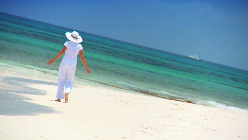 Elegant young female reveling in achieving her fantasy of a luxury island vacation