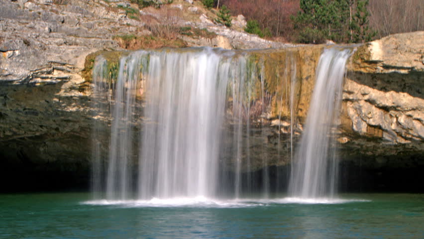 Water falling into a emerald lake in Zarecki krov 