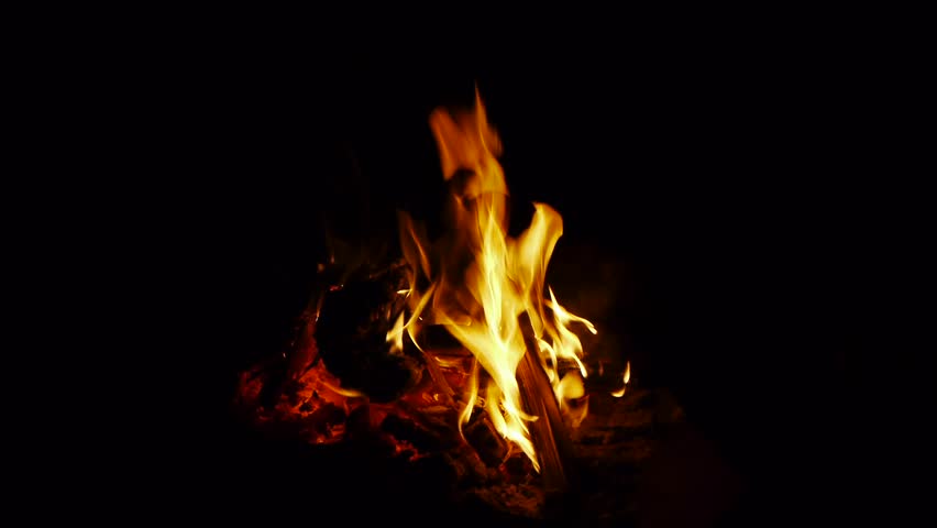 a campfire is burning in the night