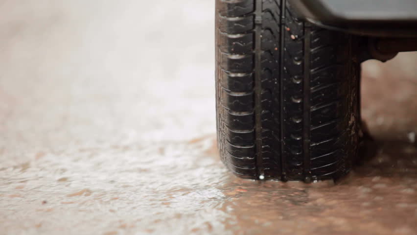 car tire in a stream of of rainwater