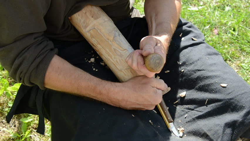 carver hands carving wooden object