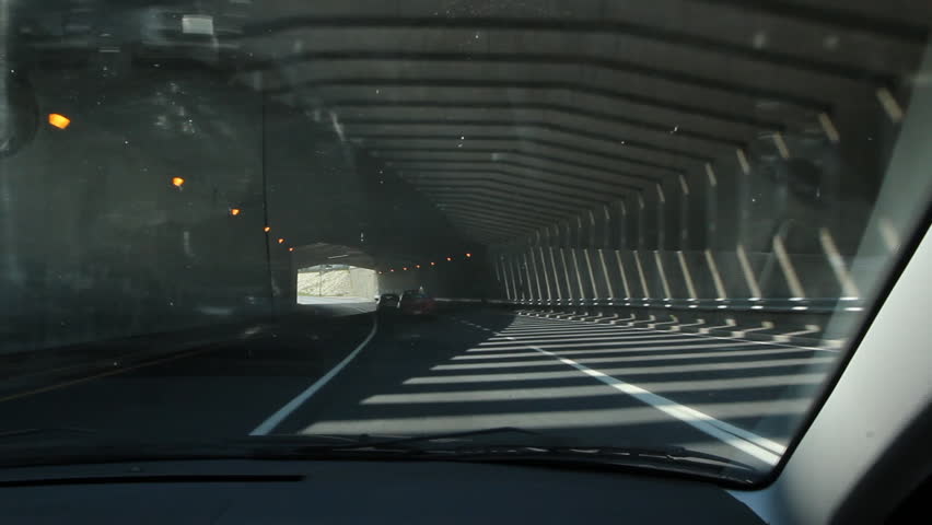 Flickering tunnel. Driving through a tunnel with sunlight and shadows creating a flickering effect. Montreal, Quebec, Canada.  