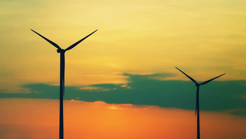 Nice sunset over wind turbines with clouds